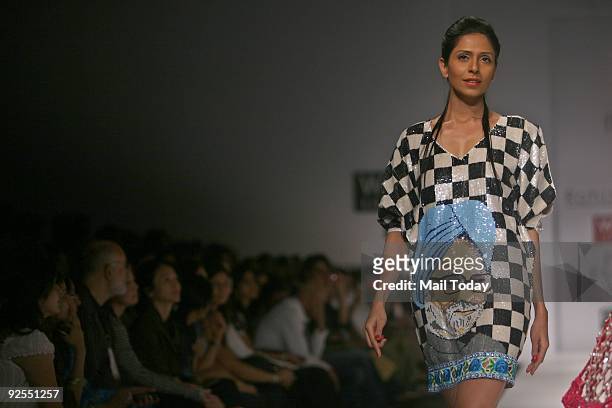 Model displays an outfit designed by Rohit Mittal with Prime Minister Manmohan Singh's image on it at the fourth day of the Wills India Fashion Week...