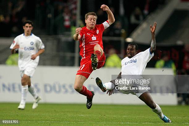 Andreas Lambertz of Duesseldorf is challenged by Godfried Aduobe of Karlsruhe during the Second Bundesliga match between Fortuna Duesseldorf and...