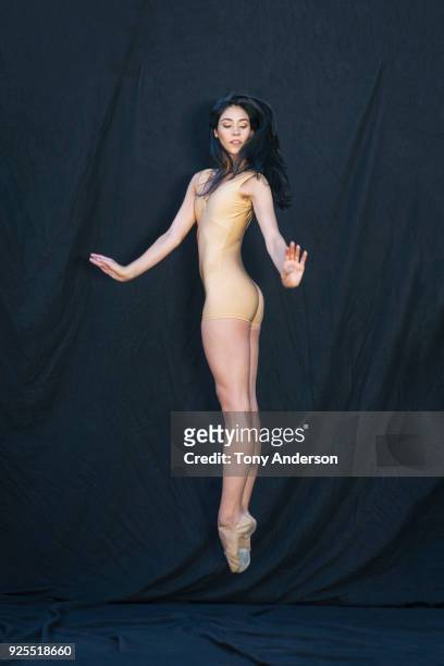 young woman ballet dancer against black background - hautfarbige schuhe stock-fotos und bilder