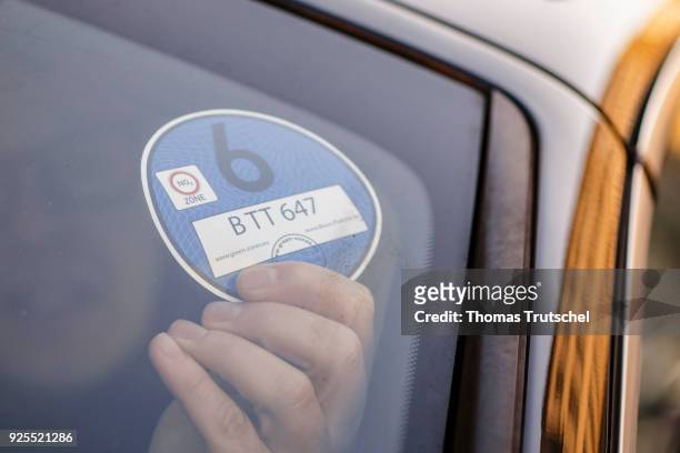 Berlin, Germany A blue badge to regulate diesel driving bans is stuck in the windshield of a car on February 28, 2018 in Berlin, Germany.