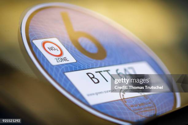 Berlin, Germany A blue badge to regulate diesel driving bans stucks in the windshield of a car on February 28, 2018 in Berlin, Germany.