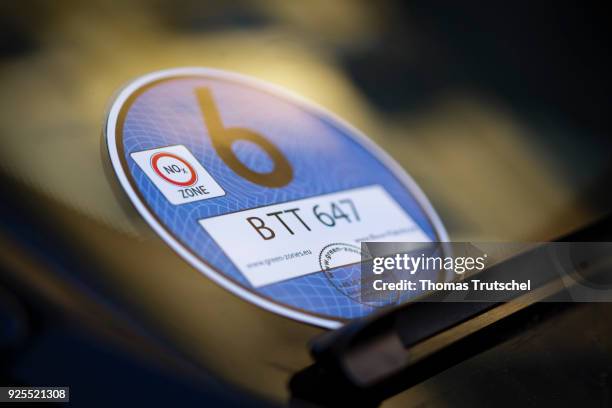 Berlin, Germany A blue badge to regulate diesel driving bans stucks in the windshield of a car on February 28, 2018 in Berlin, Germany.