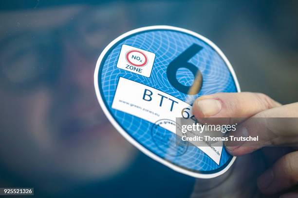 Berlin, Germany A blue badge to regulate diesel driving bans is stuck in the windshield of a car on February 28, 2018 in Berlin, Germany.