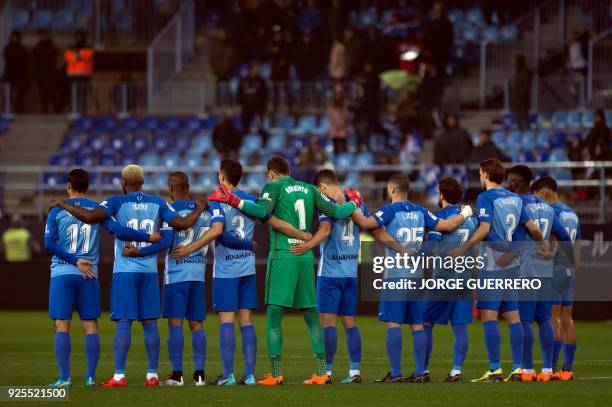 Malaga players observe a minute of silence for former Spanish footbal star Enrique Castro "Quini" who died on February 27 before the Spanish league...