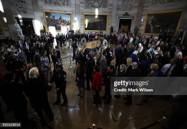 Members of the public file through the Rotunda of the U.S. Capitol to view the casket containing the remains of evangelist Rev. Billy Graham, on...