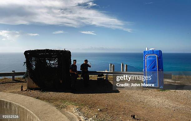 Marines look out over the Caribbean from a hilltop observation post October 28, 2009 at the U.S. Naval Base at Guantanamo Bay, Cuba. The base,...