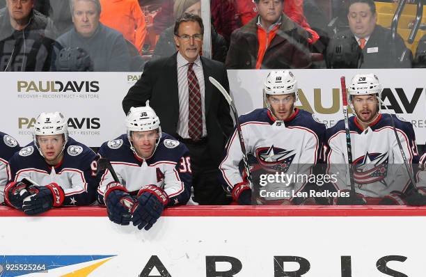 Head Coach John Tortorella of the Columbus Blue Jackets watches the play on the ice behind Artemi Panarin, Boone Jenner, Alexander Wennberg and...