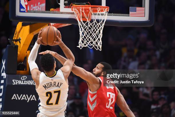 Brandan Wright of the Houston Rockets attempts to block a shot by Jamal Murray of the Denver Nuggets at Pepsi Center on February 25, 2018 in Denver,...