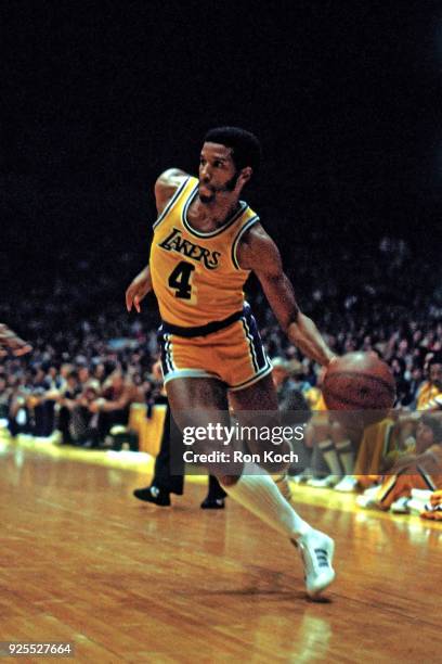 Adrian Dantley of the Los Angeles Lakers dribbles at the Great Western Forum in Inglewood, California. NOTE TO USER: User expressly acknowledges and...