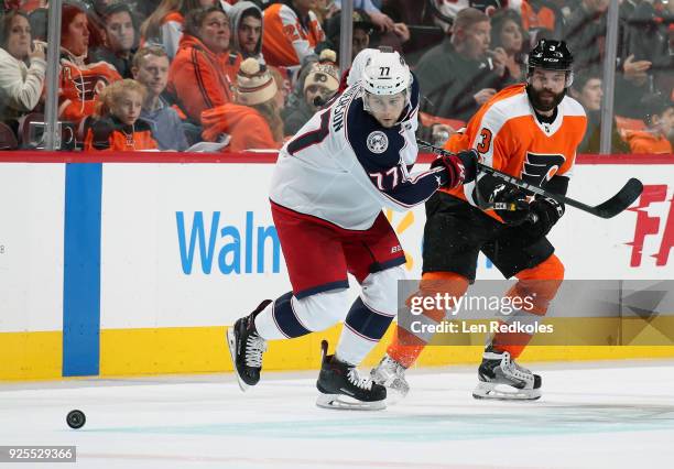 Radko Gudas of the Philadelphia Flyers battles for the loose puck against Josh Anderson of the Columbus Blue Jackets on February 22, 2018 at the...