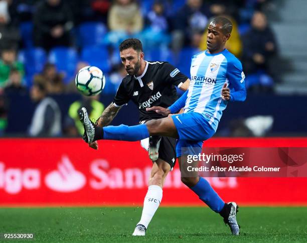 Miguel Layun of Sevilla FC duels for the ball with Diego Rolan of Malaga CF during the La Liga match between Malaga CF and Sevilla FC at Estadio La...