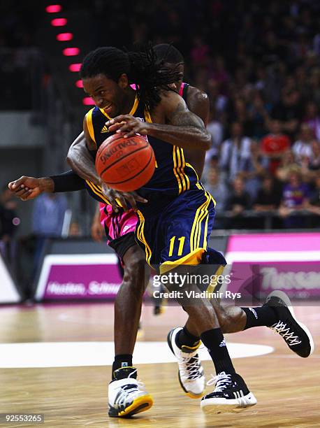 Julius Jenkins of Alba passes over Patrick Flomo of Baskets during the Beko Basketball Bundesliga game between Telekom Baskets and Alba Berlin at...