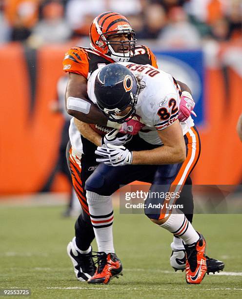 Dhani Jones of the Cincinnati Bengals tackles Greg Olsen of the Chicago Bears during the NFL game at Paul Brown Stadium on October 25, 2009 in...