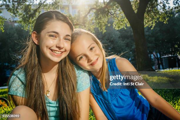 portrait of smiling caucasian girls in park - sister stock pictures, royalty-free photos & images