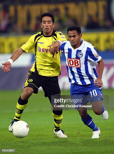 Lucas Barrios of Dortmund tackles Raffael of Berlin during the Bundesliga match between Borussia Dortmund and Hertha BSC Berlin at the Signal Iduna...