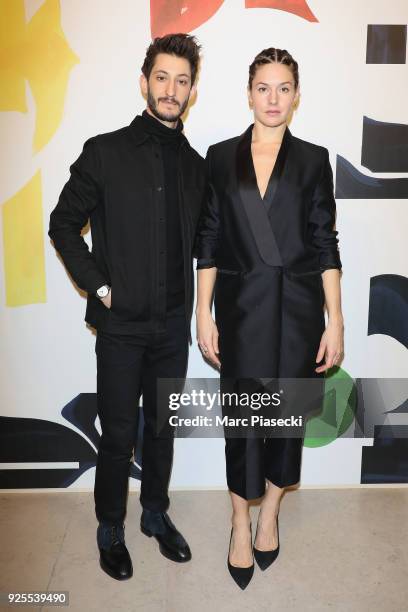 Pierre Niney and Natasha Andrews attend the H&M show as part of the Paris Fashion Week Womenswear Fall/Winter 2018/2019 on February 28, 2018 in...