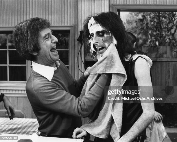 Comedian Soupy Sales wipes a pie off of the face of rock star Alice Cooper's face on his new show at the KTLA studios in1979 in Los Angeles,...