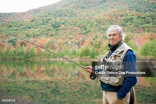 portrait of boomer man fly fishing - manchester vermont fotografías e imágenes de stock