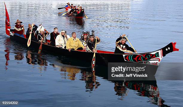 Chief Gibby Jacob and other Canadian First Nation Chiefs transport the Olympic Flame in a miners lantern across Victoria harbour during the torch...