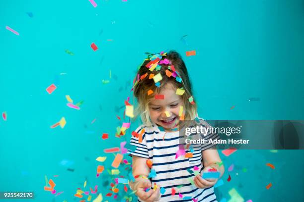 colorful confetti falling on caucasian girl - fall party inside stock-fotos und bilder