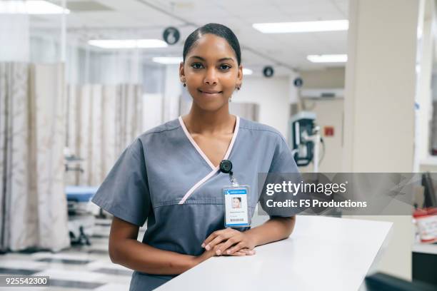 portrait of smiling african american nurse in hospital - nurse station stock pictures, royalty-free photos & images