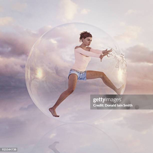 woman escaping from cracking glass sphere - bulle protection photos et images de collection