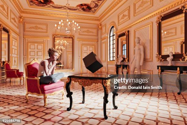 woman watching floating cube in sitting room - cube sat stock pictures, royalty-free photos & images