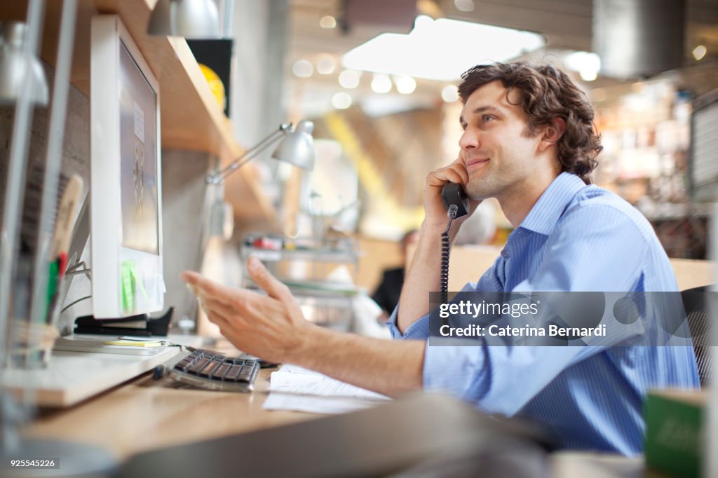 Hispanic businessman talking on telephone