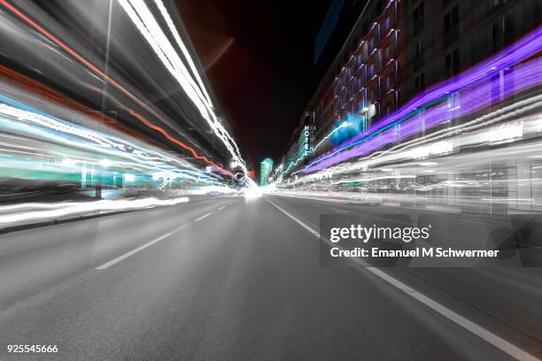 driving fast in berlin - looking backwards - long exposure - man running away stock-fotos und bilder