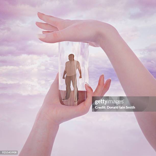 hands of woman trapping man in glass container - puppet stock pictures, royalty-free photos & images