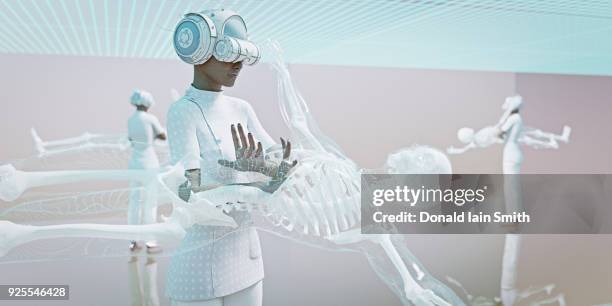 doctors wearing virtual reality goggles examining skeleton - medical procedure ストックフォトと画像