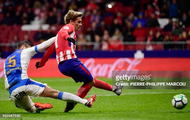 Atletico Madrid's French forward Antoine Griezmann shoots to score a goal during the Spanish league football match Club Atletico de Madrid against...