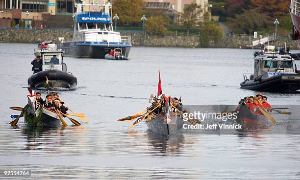 Canadian First Nation Chiefs transport the Olympic Flame in a miners lantern across Victoria harbour during the torch lighting ceremonies on October...