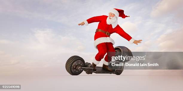 santa riding futuristic skateboard - santa riding stock pictures, royalty-free photos & images