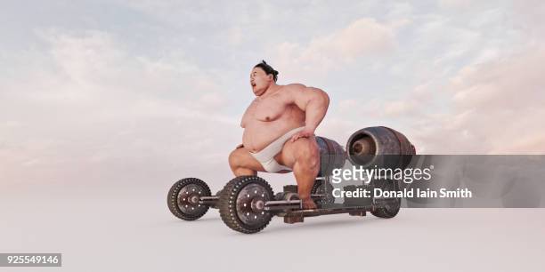 sumo wrestler riding futuristic skateboard - sumo wrestling stock pictures, royalty-free photos & images