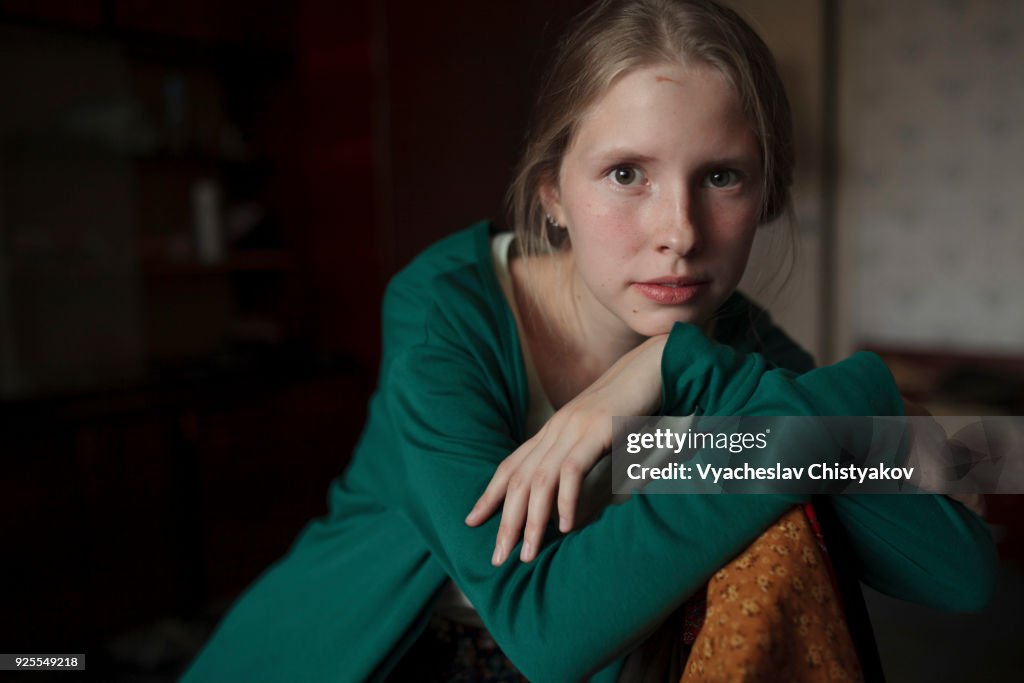 Portrait of pensive Caucasian woman leaning on chair