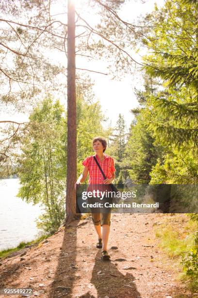 caucasian woman hiking near river - females hiking stock pictures, royalty-free photos & images