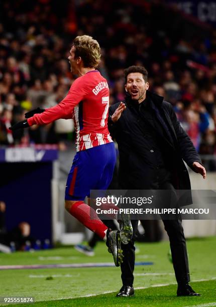 Atletico Madrid's French forward Antoine Griezmann celebrates his second goal beside Atletico Madrid's Argentinian coach Diego Simeone during the...