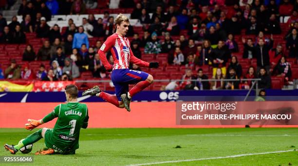 Leganes' Spanish goalkeeper Pichu Cuellar vies with Atletico Madrid's French forward Antoine Griezmann during the Spanish league football match Club...