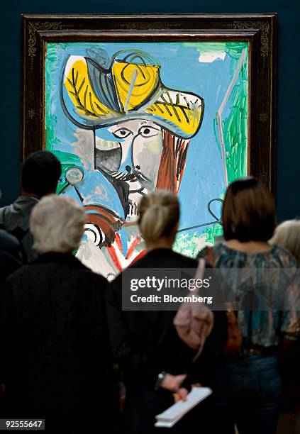 Members of the media look over "Buste d'homme" by Pablo Picasso during a preview of the Impressionist and Modern Art fall sales at Sotheby's in New...