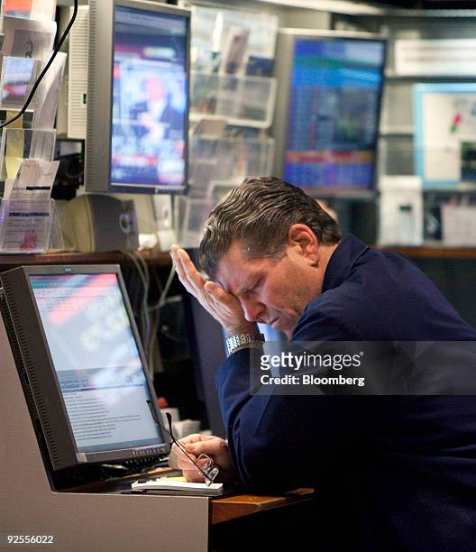 Trader rubs his eyes on the floor of the New York Stock Exchange at the end of the trading day in New York, U.S., on Friday, Oct. 30, 2009. NYSE...