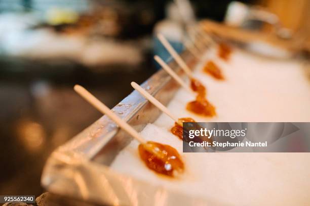 maple toffy on ice - quebec city food stock pictures, royalty-free photos & images