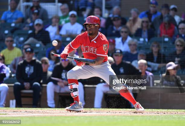 Eric Young Jr of the Los Angeles Angels of Anaheim bunts the ball against the Colorado Rockies at Salt River Fields at Talking Stick on February 27,...