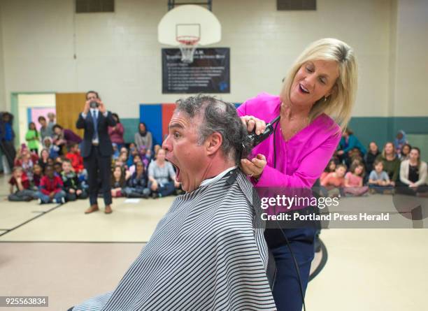 Mayor Ethan Strimling has his head shaved by Presumscot Elementary School Principal Cynthia Loring, after losing a bet that the New England Patriots...
