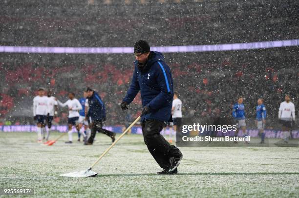 Ground Staff clear snow from the pitch during the Emirates FA Cup Fifth Round Replay match between Tottenham Hotspur and Rochdale at Wembley Stadium...