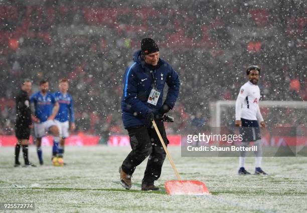 Ground Staff clear snow from the pitch during the Emirates FA Cup Fifth Round Replay match between Tottenham Hotspur and Rochdale at Wembley Stadium...