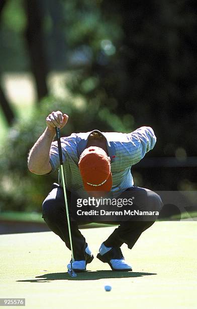 Hal Sutton of the USA, doubles over while lining up his putt, suffering from a back injury during the first round of the 2001 Accenture Match Play...