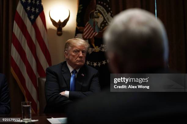 President Donald Trump listens to Vice President Mike Pence during a meeting with bipartisan members of the Congress at the Cabinet Room of the White...