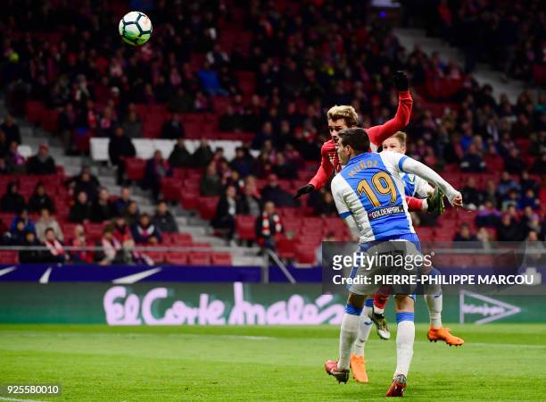 Atletico Madrid's French forward Antoine Griezmann heads he ball to score a hat-trick during the Spanish league football match Club Atletico de...