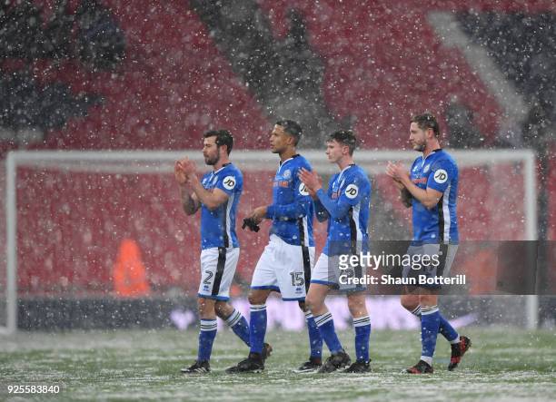 L-r Joseph Rafferty, Joseph Thompson, Daniel Adshead and Steven Davies of Rochdale walk off in the snow after the Emirates FA Cup Fifth Round Replay...